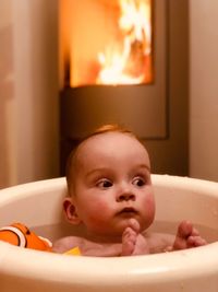 Cute baby boy relaxing in bathtub at home