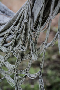 Close-up of rope tied on wooden post