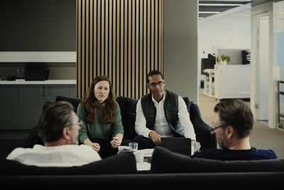 Group of business people having meeting in lobby