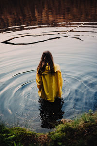 Rear view of girl standing in water
