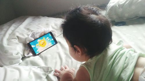 High angle view of boy using mobile phone