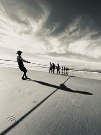 People on beach against sky