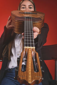 Midsection of woman playing guitar