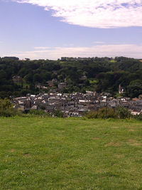 Houses on grassy field against sky