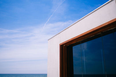 Building by sea against sky