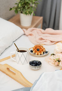 Viennese waffles and coffee in bed. morning breakfast.