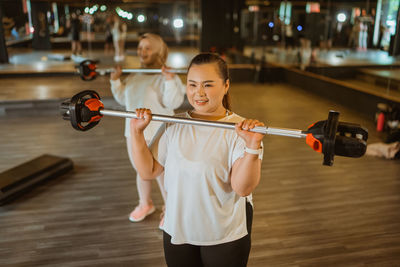 Portrait of young woman exercising in gym