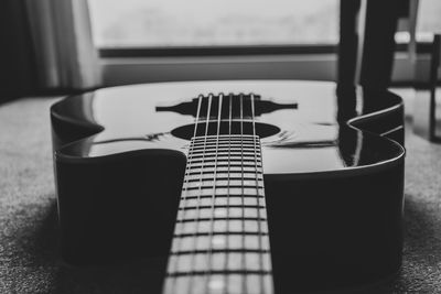 Close-up of guitar on floor