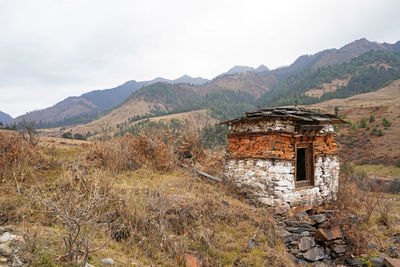 Small old white and brown stone stupa in the mountains in eastern bhutan