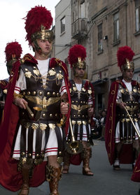 Men standing against built structure