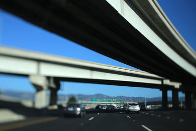 Low angle view of bridge against clear blue sky