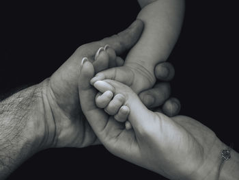 Cropped image of person against black background