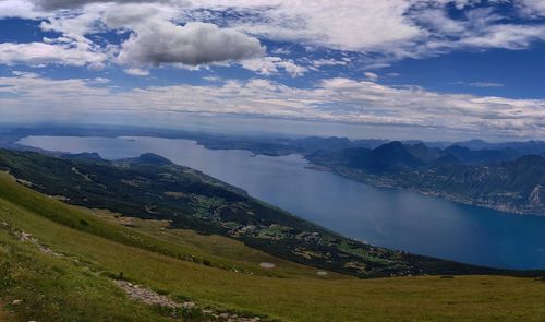 Scenic view of land and mountains against sky