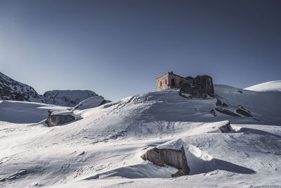 Scenic view of snowcapped mountains against clear sky