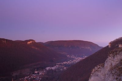 Scenic view of mountains against clear sky at dusk