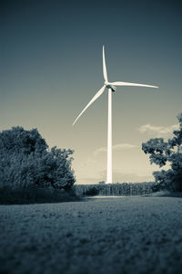Windmill on field against sky