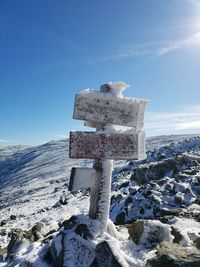 Built structure on snow covered field against sky