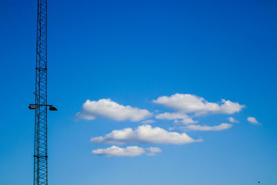 Low angle view of crane against blue sky