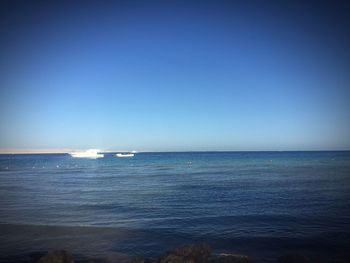 Scenic view of sea against clear blue sky