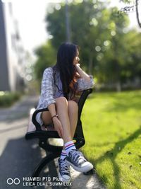 Young woman sitting on grass