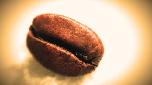 Close-up of orange slice over white background