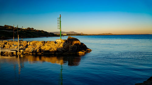 Scenic view of sea against clear blue sky