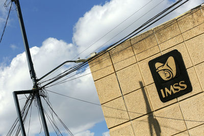 Low angle view of telephone pole against sky