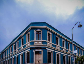 Low angle view of building against cloudy sky