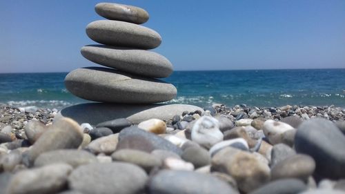 Close-up of stones stacked at beach