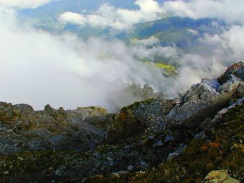 Scenic view of mountains against cloudy sky