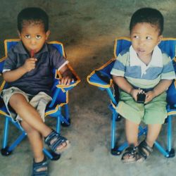 Portrait of boy sitting on chair