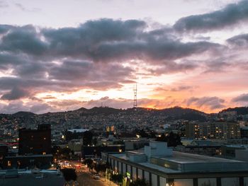 High angle view of illuminated cityscape against sky during sunset