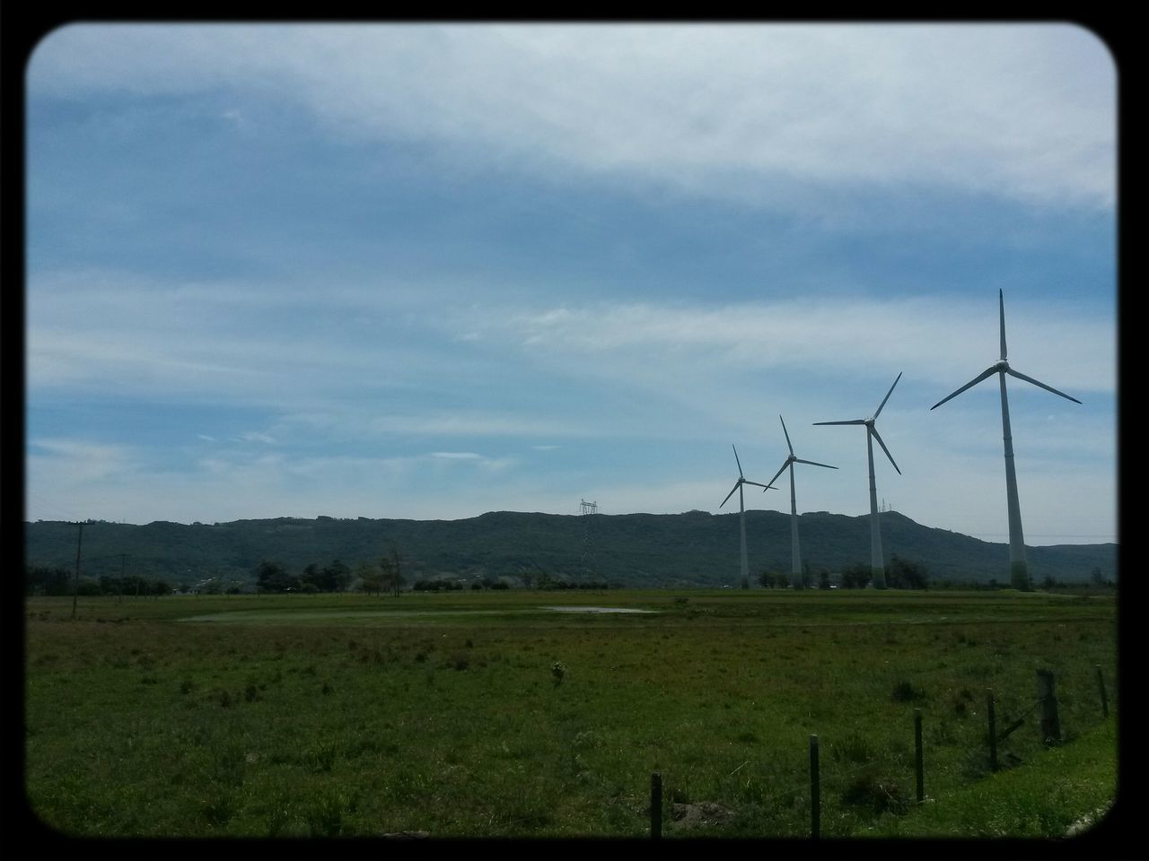 field, landscape, transfer print, rural scene, grass, sky, fuel and power generation, fence, tranquil scene, wind power, alternative energy, tranquility, agriculture, wind turbine, farm, environmental conservation, auto post production filter, nature, grassy, scenics