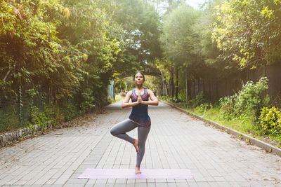 Women making yoga on the park