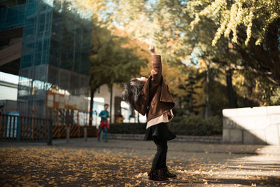 Full length of girl standing on road