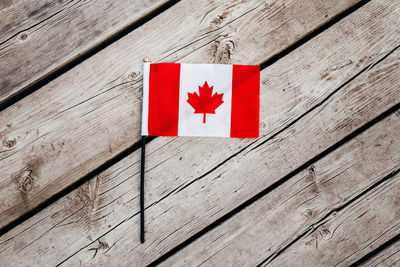 Close-up of red flag on wooden table