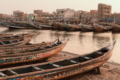 Colourful canoes on senegal river banks on sunset 