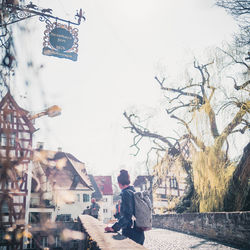 Rear view of man on street against sky