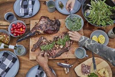 Summer barbecue spread with steak and venison and chimichurri