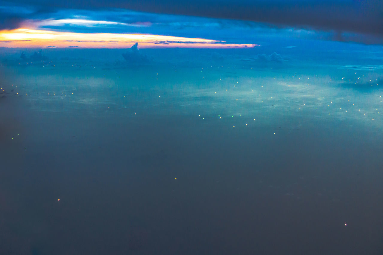 AERIAL VIEW OF SEA AGAINST SKY DURING SUNSET