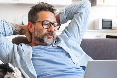 Portrait of senior man using laptop at home