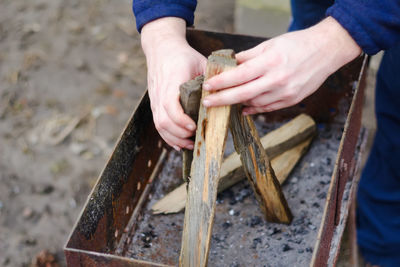 Cropped hand of man working on wood