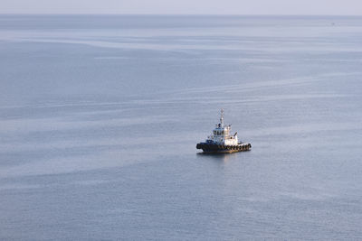 Ship sailing on sea against sky