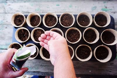 Cropped hand planting seeds