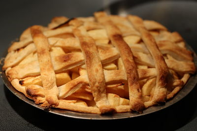 Close-up of meat and fries in plate on table