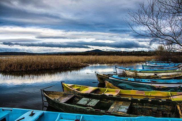 water, nautical vessel, boat, lake, sky, moored, tranquility, tranquil scene, transportation, mode of transport, scenics, cloud - sky, beauty in nature, nature, cloud, tree, calm, pier, cloudy, idyllic