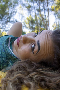 Close-up portrait of smiling woman lying down