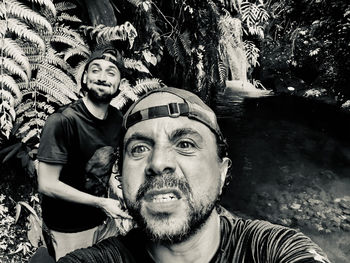 Portrait of young man with arms raised