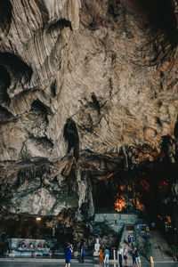 Group of people on rock in cave