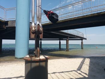 View of pier on beach against sky